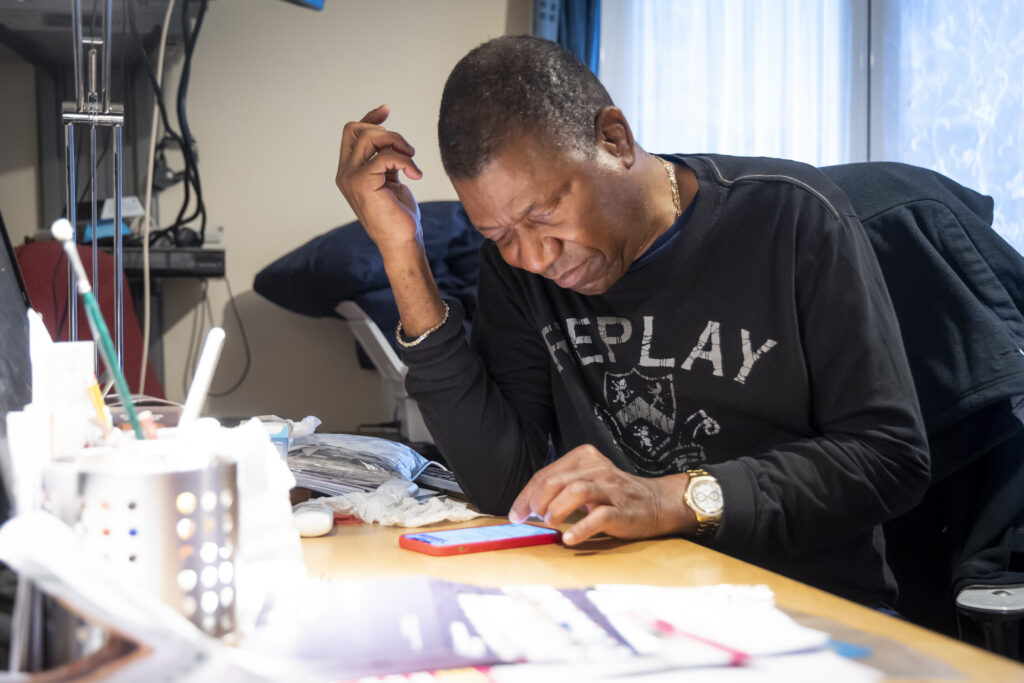 man sitting at desk using phone