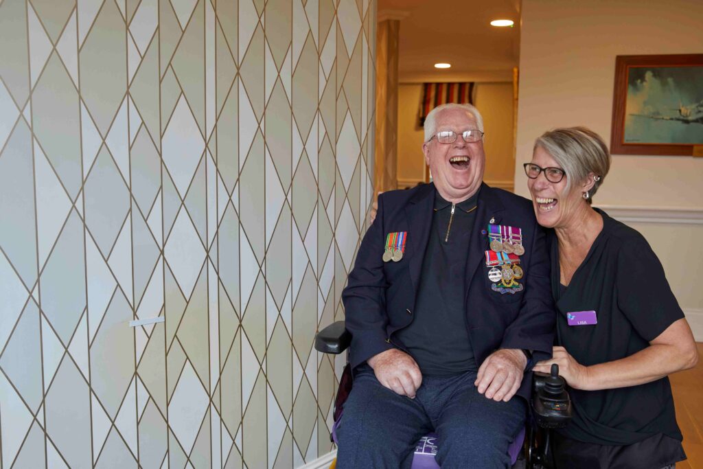 Male veteran in care home with a carer